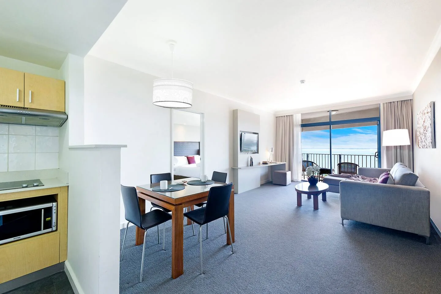 An open-plan living and dining area has a kitchen along one side.