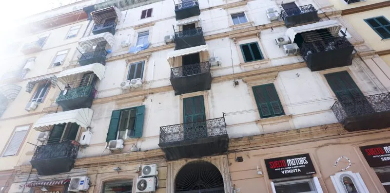 A multi-story building facade with balconies and windows.