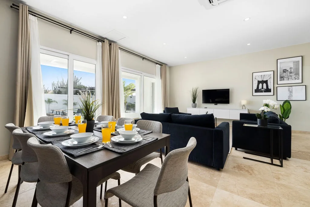 Your open-concept living and dining space features modern comfort, fresh juice at the ready, and sun-drenched windows framing peaceful outdoor views you'll love.