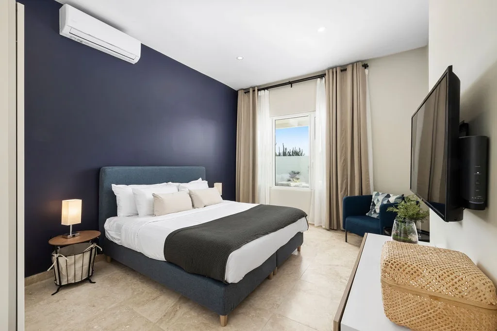 Sink into the plush bed with crisp linens and enjoy your favorite shows on the wall-mounted TV, all while the air conditioning keeps your space perfectly cool.