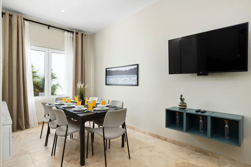 Gather around your dining table for breakfast with orange juice ready, while staying entertained with the flat-screen TV and enjoying natural light from the window.