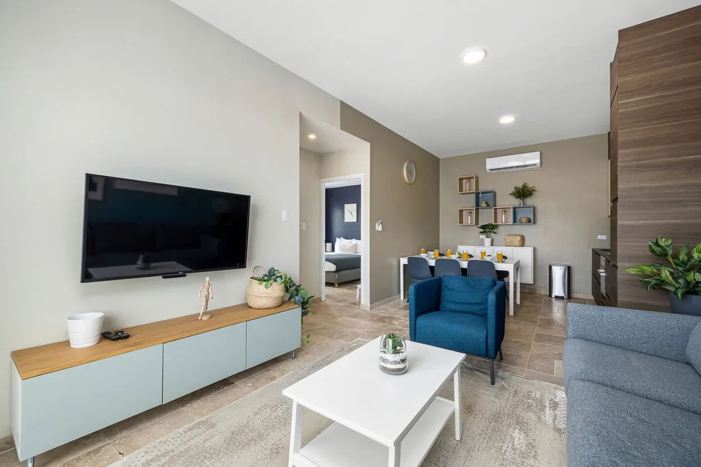 Unwind in your spacious living area with modern décor, plush seating, and entertainment ready—perfect for relaxing after a day of adventure.