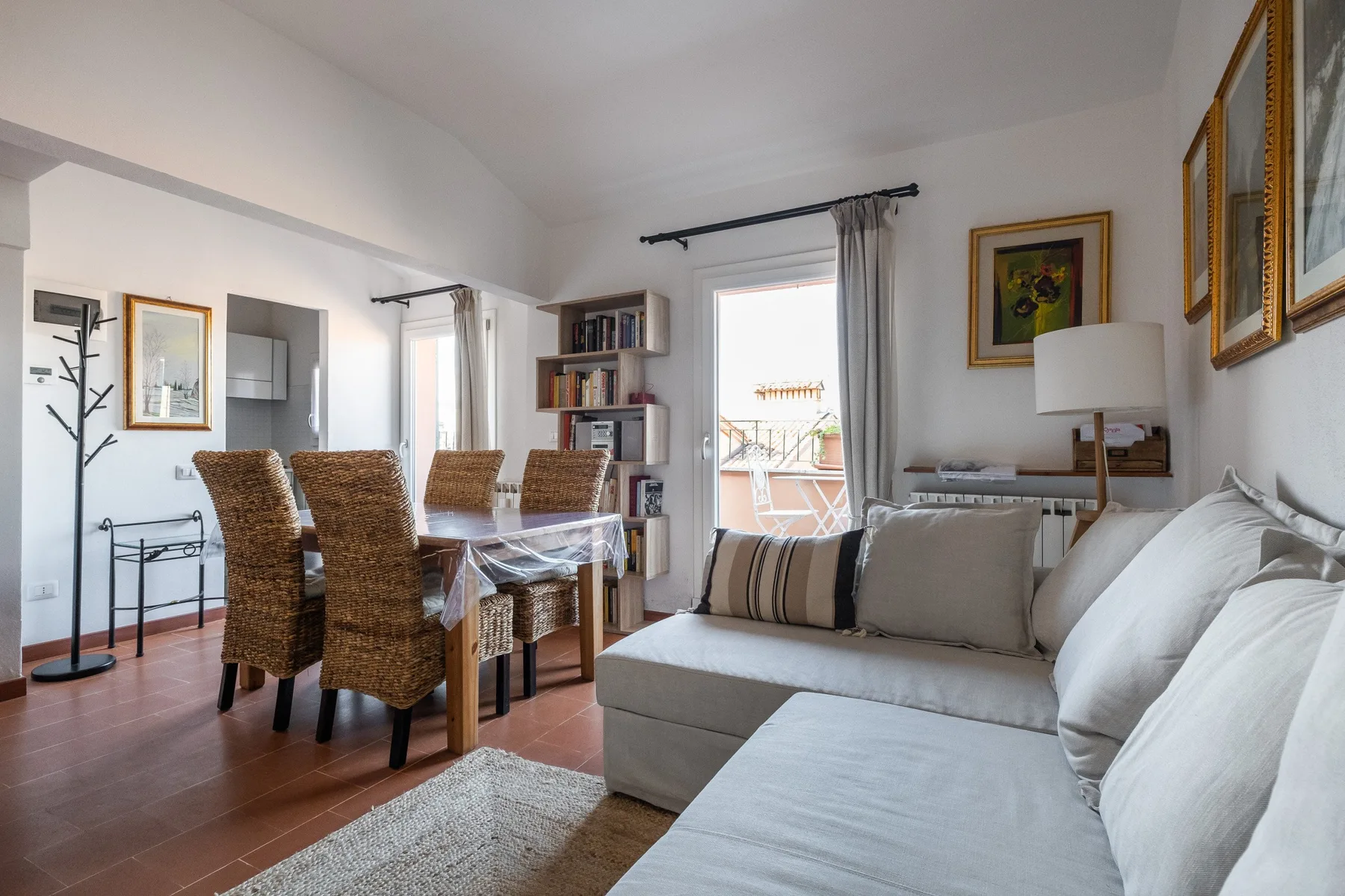 A living and dining area with a sofa, dining table, and chairs.