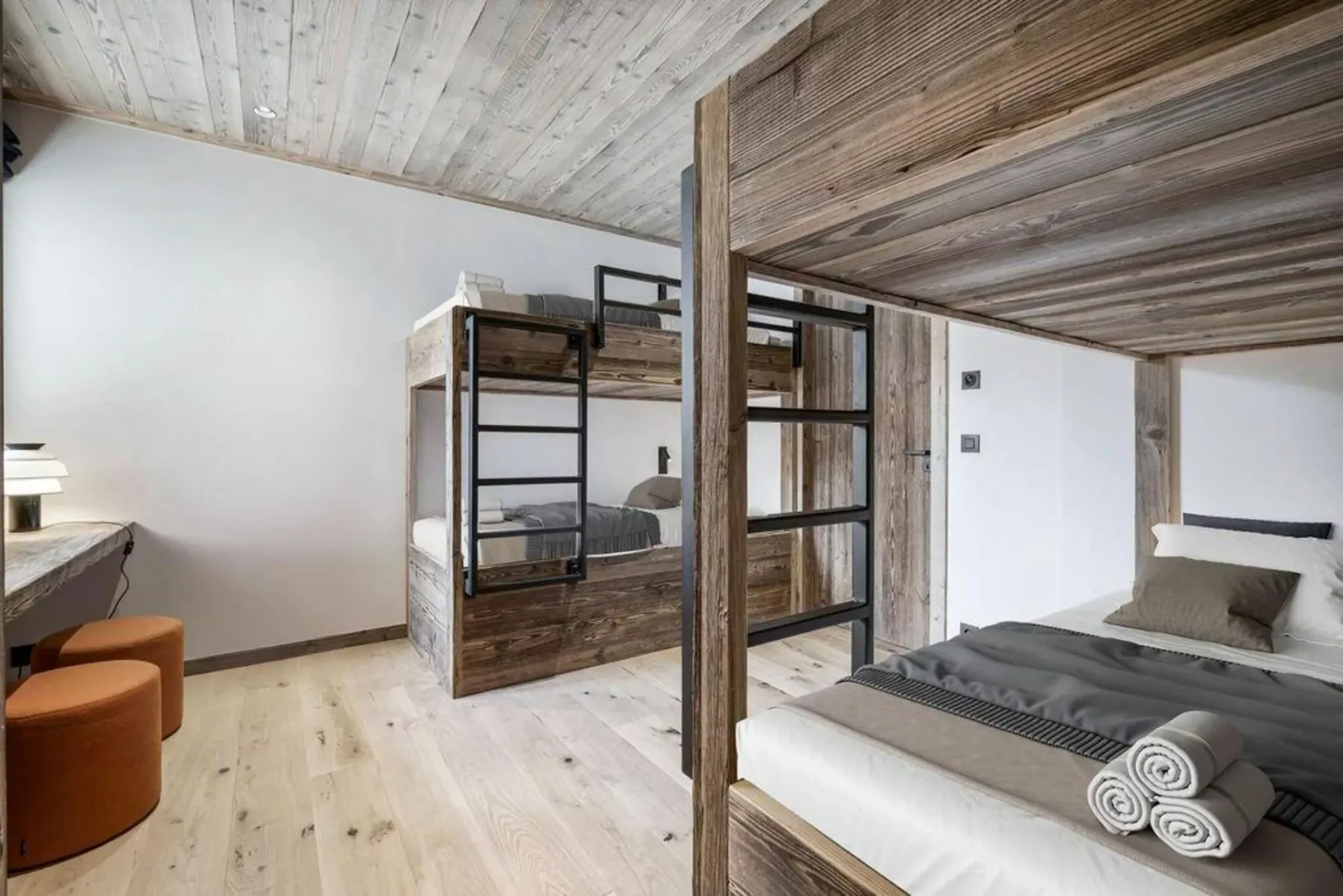A bedroom with a bunk bed and a separate sleeping area.