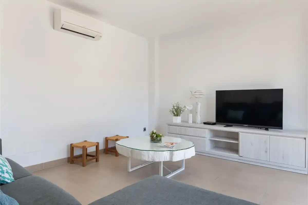 A living room with a television, coffee table, and seating.