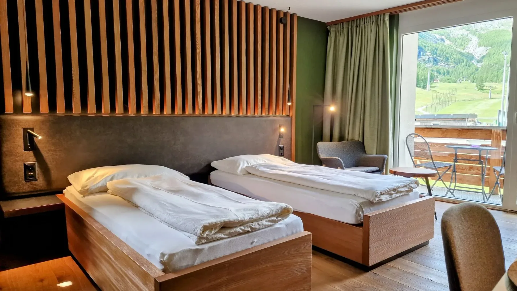 Hotel room with two beds and a large window.