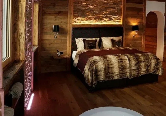 Wood-paneled bedroom with a large bed.
