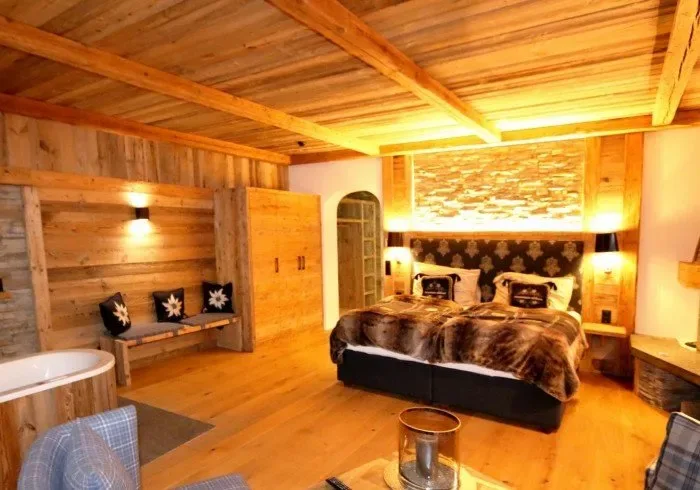 Bedroom with stone fireplace and hot tub.