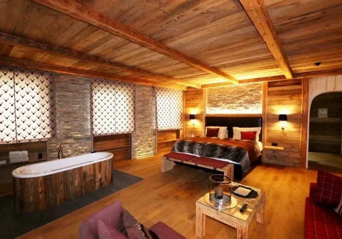 Suite interior with a hot tub and massage table.