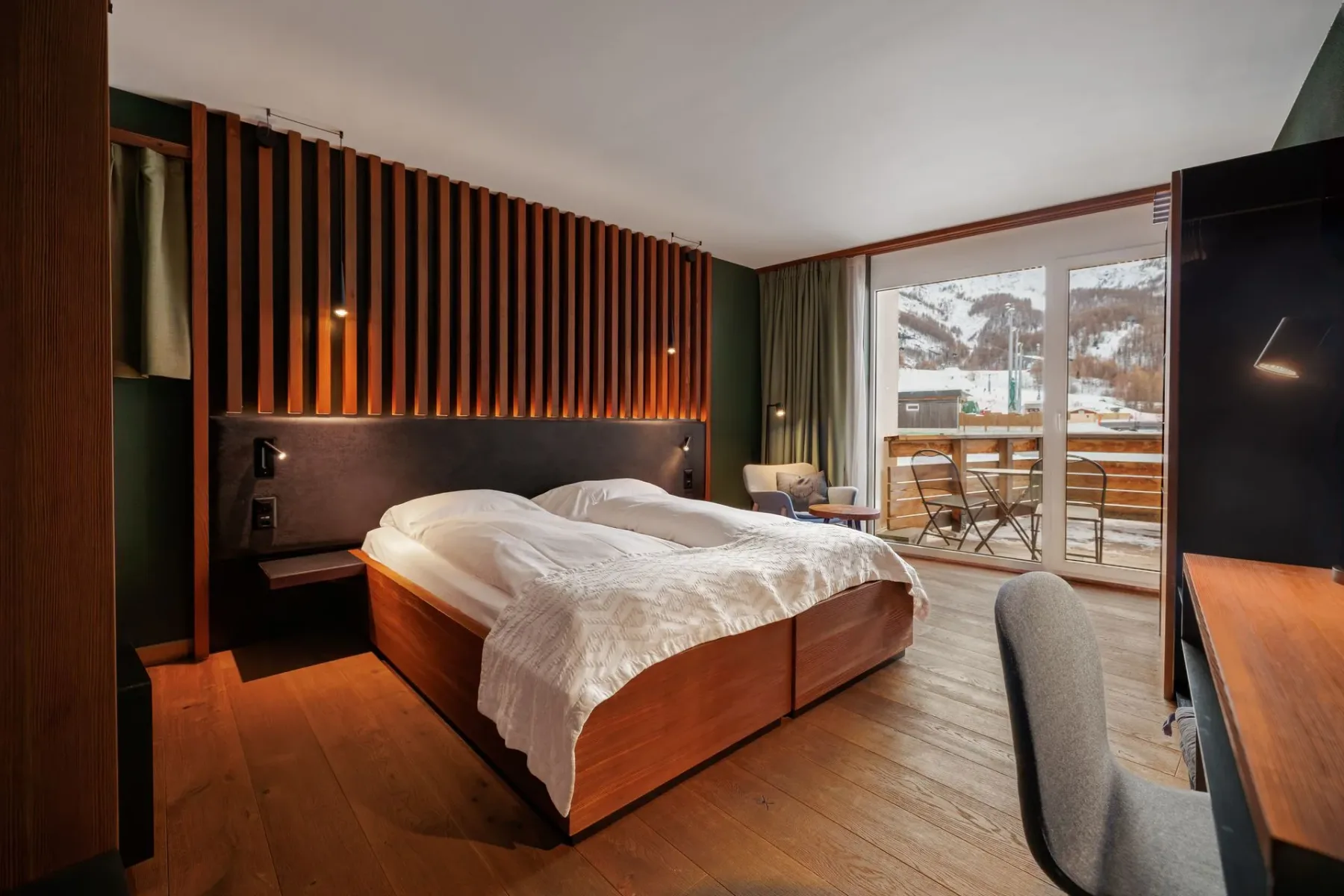 Bedroom with wood accents and balcony doors.
