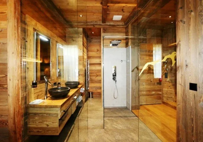 Bathroom with glass shower and double-sink vanity.