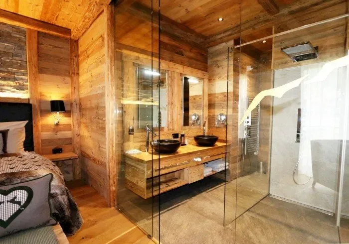 Bathroom vanity and shower, with a bedroom visible beyond.