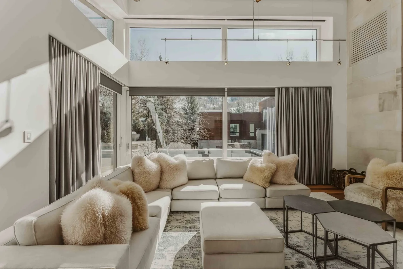 A bright living room with seating arranged around a low coffee table.