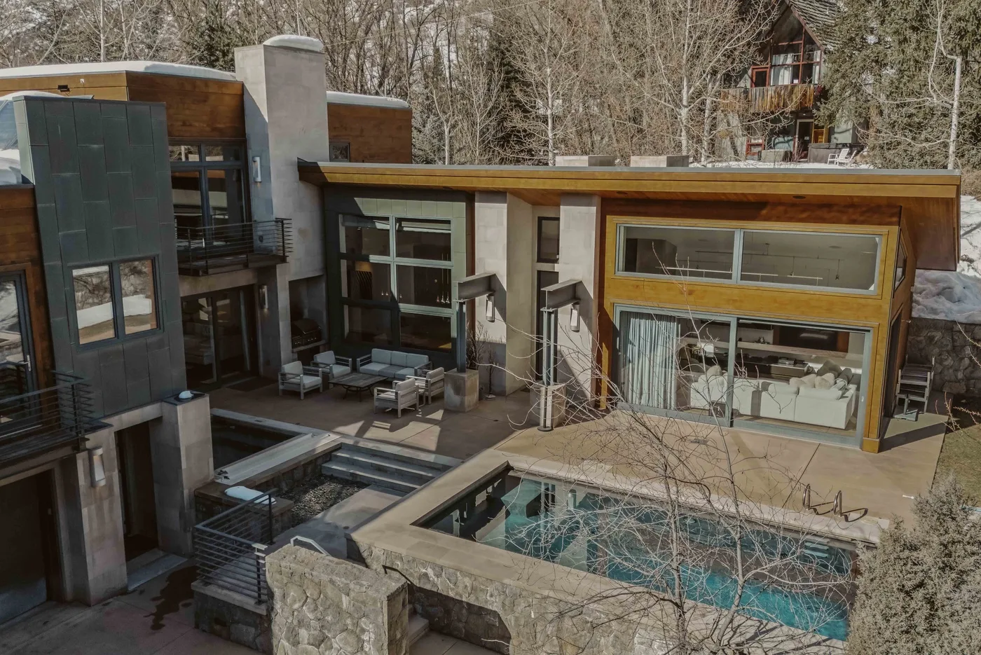 A modern house with a swimming pool and large windows.