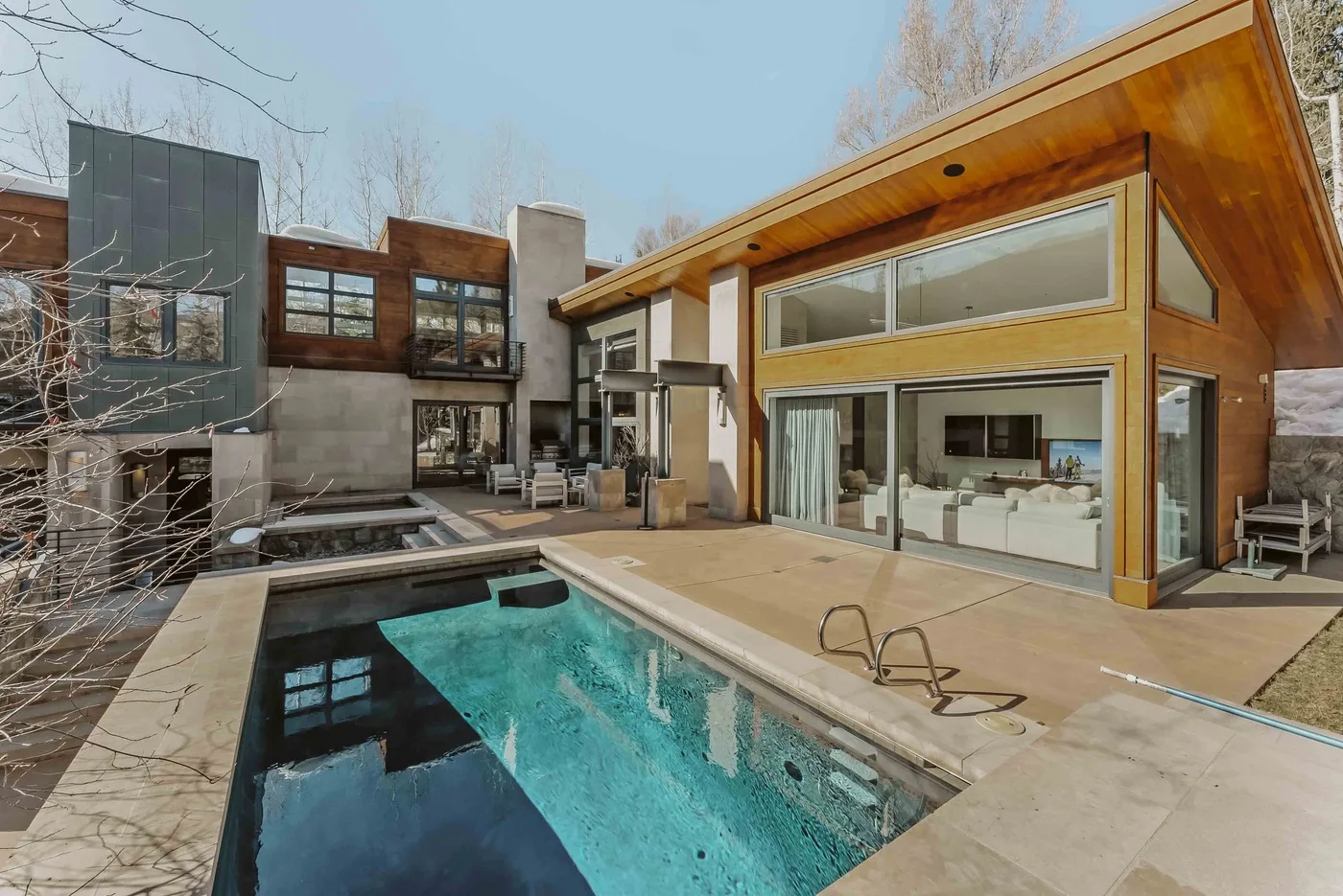 A modern house with a swimming pool and large glass windows.