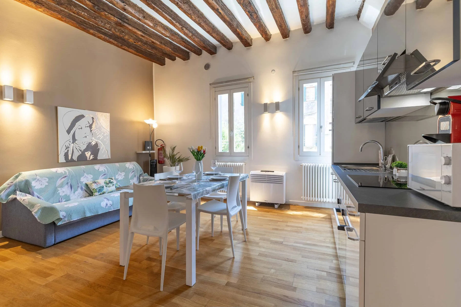 A bright open-plan living and dining area with a compact kitchen along one side.