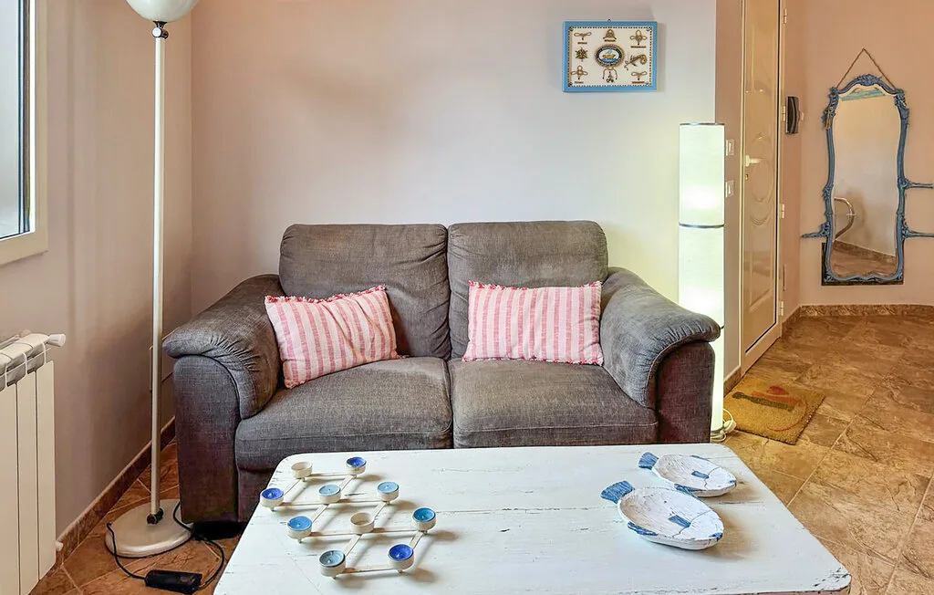 A living room with a gray sofa and a low white coffee table.