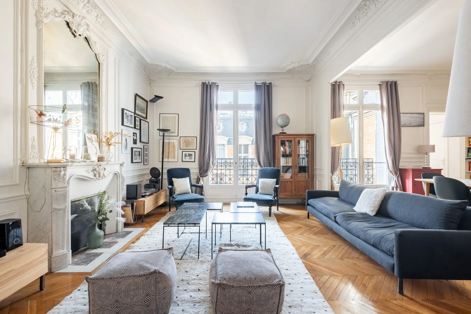 Bright living room with seating arranged around a coffee table.