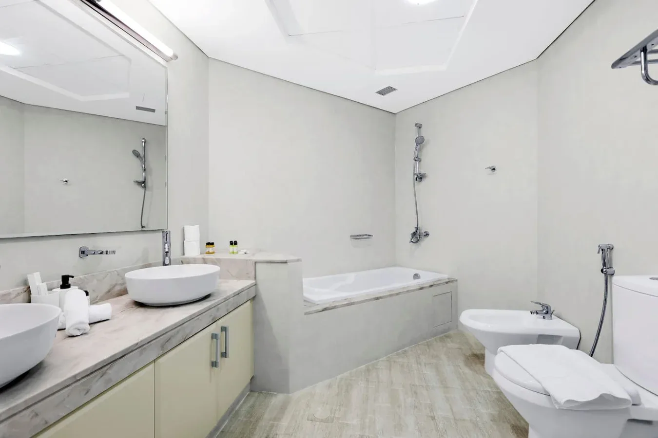 A bright bathroom with a bathtub, sink, and toilet.