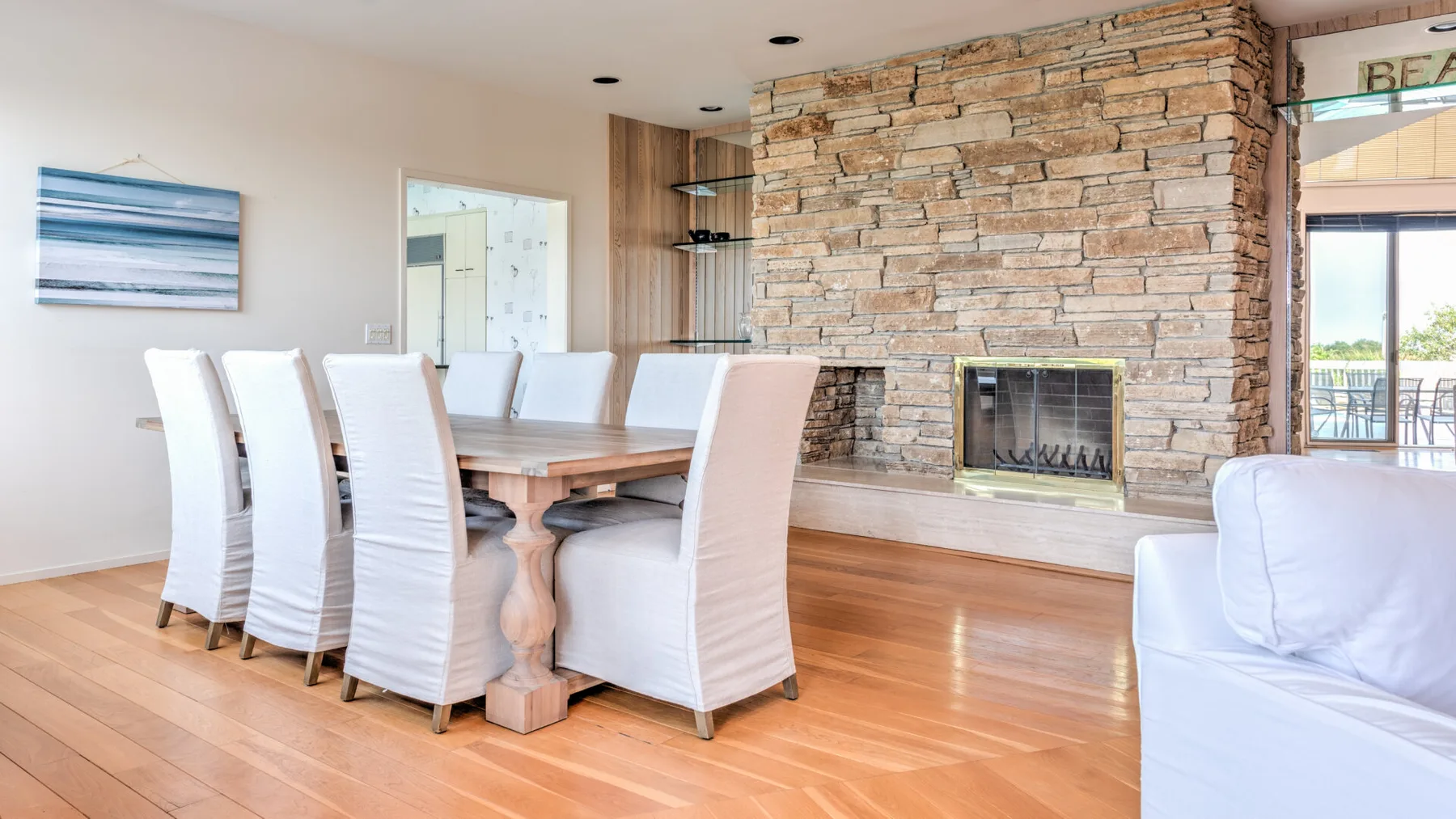 Comedor con una mesa larga y una chimenea de piedra.