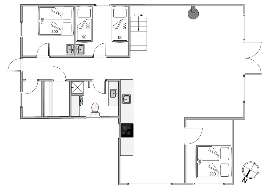 A floor plan showing several rooms, beds, a bathroom, and a central open area.