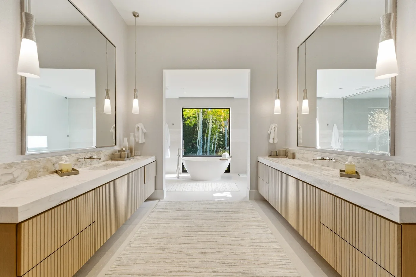 A spacious bathroom vanity area with long counters and a freestanding tub.