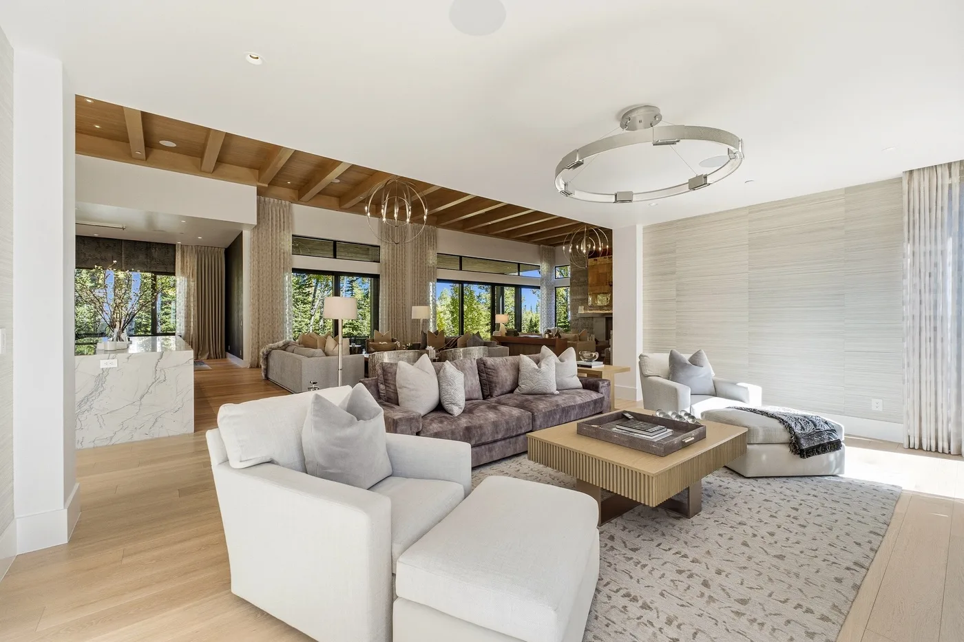 A bright living room with seating arranged around a low coffee table.
