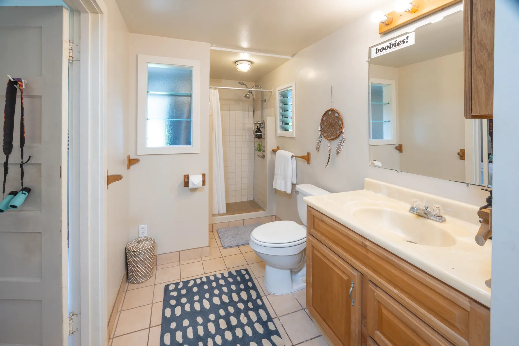 A bathroom with a sink, toilet, and glass shower.
