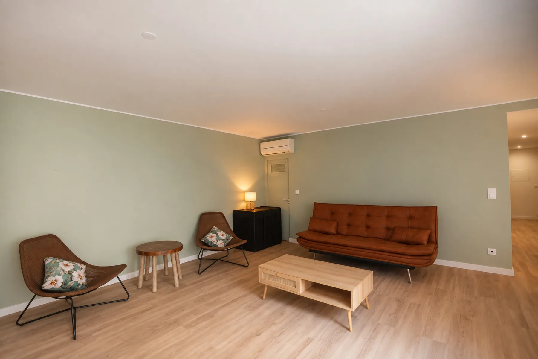 A living room with seating, a coffee table, and a small side table.