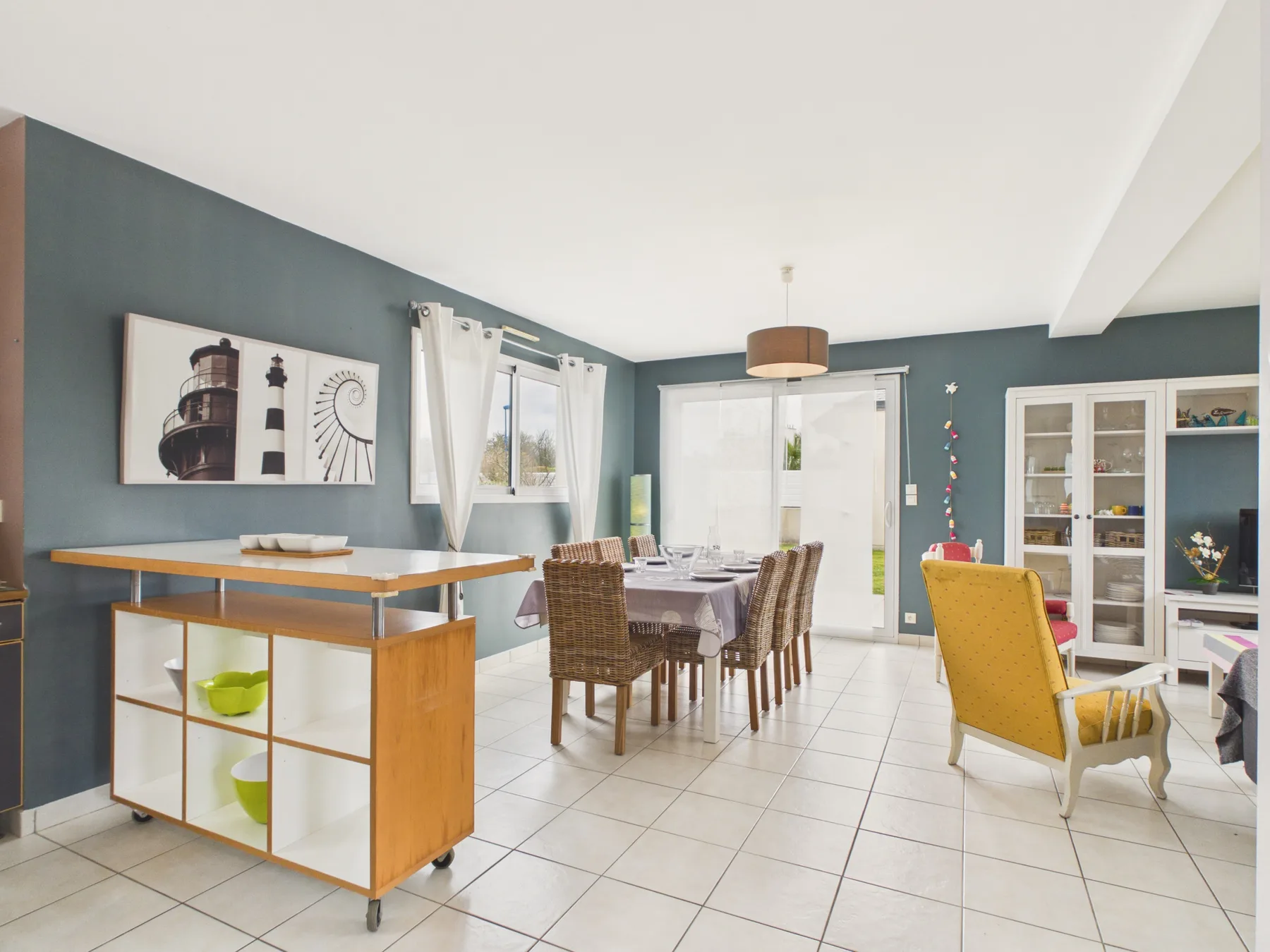 A dining area with a table and chairs beside a kitchen island.