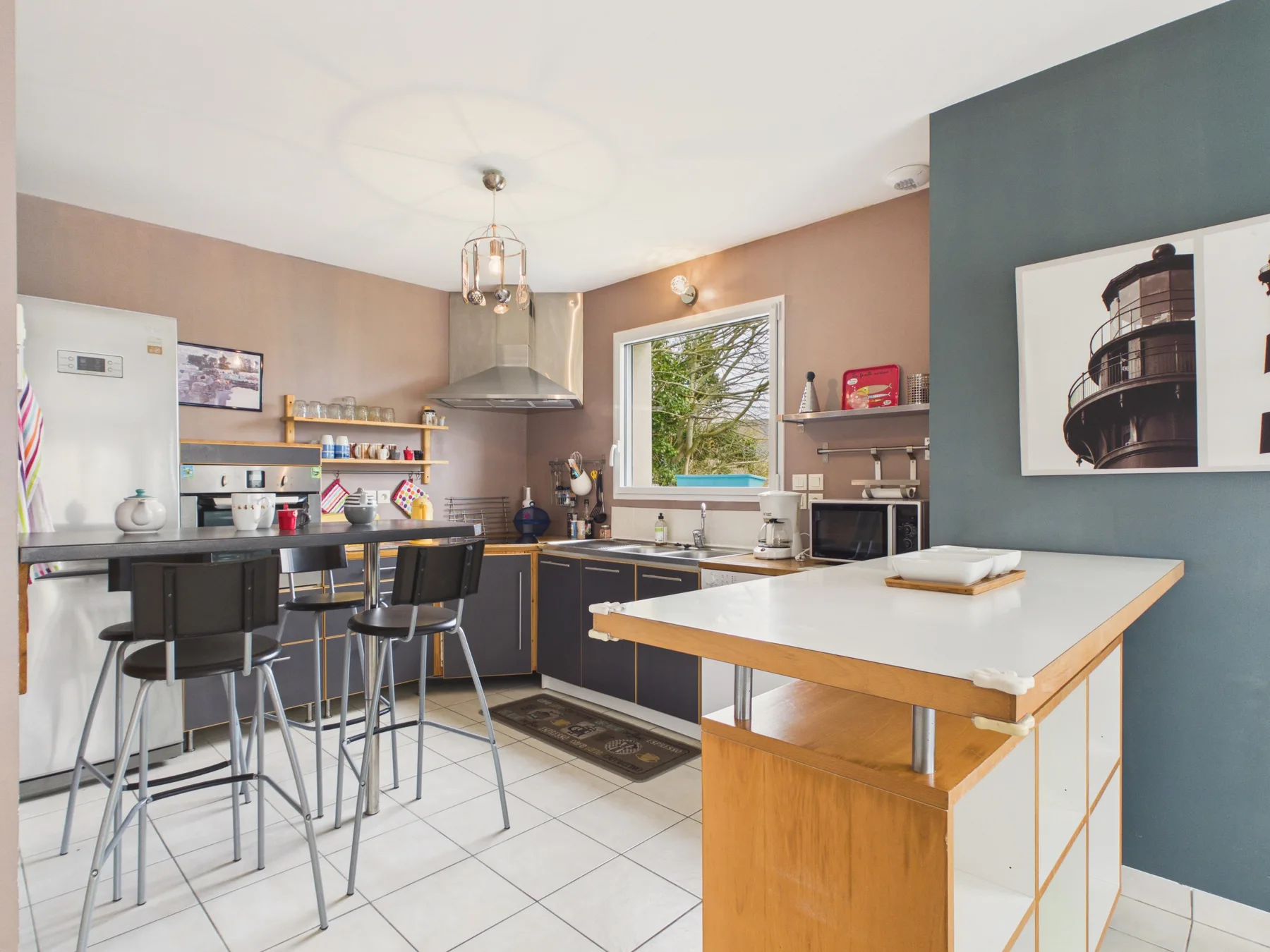 A kitchen with dark cabinets and a central island.