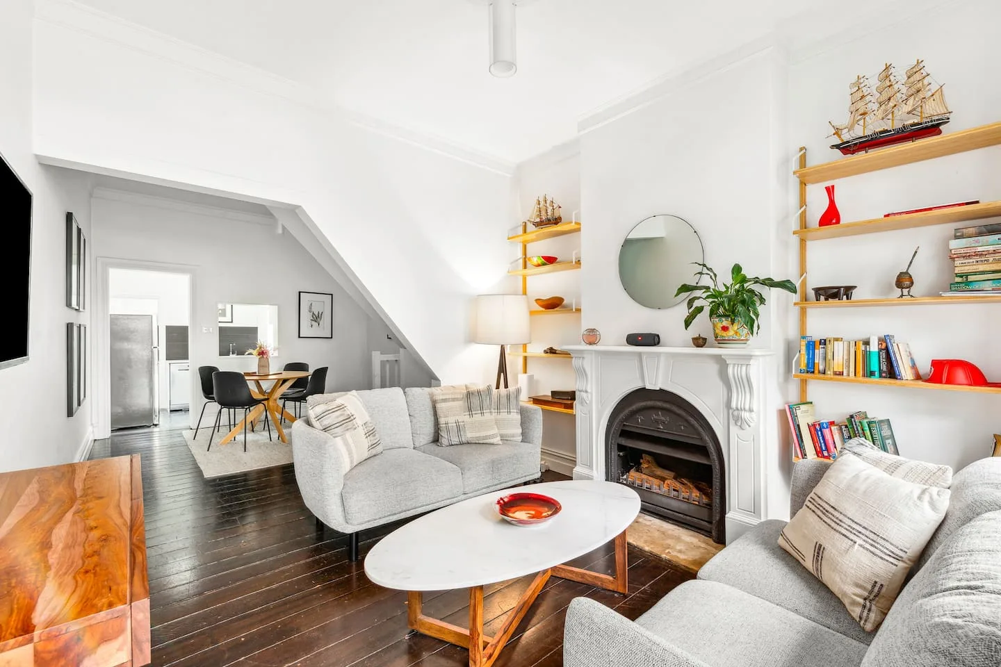Una sala luminosa con asientos alrededor de una mesa de centro y una chimenea.