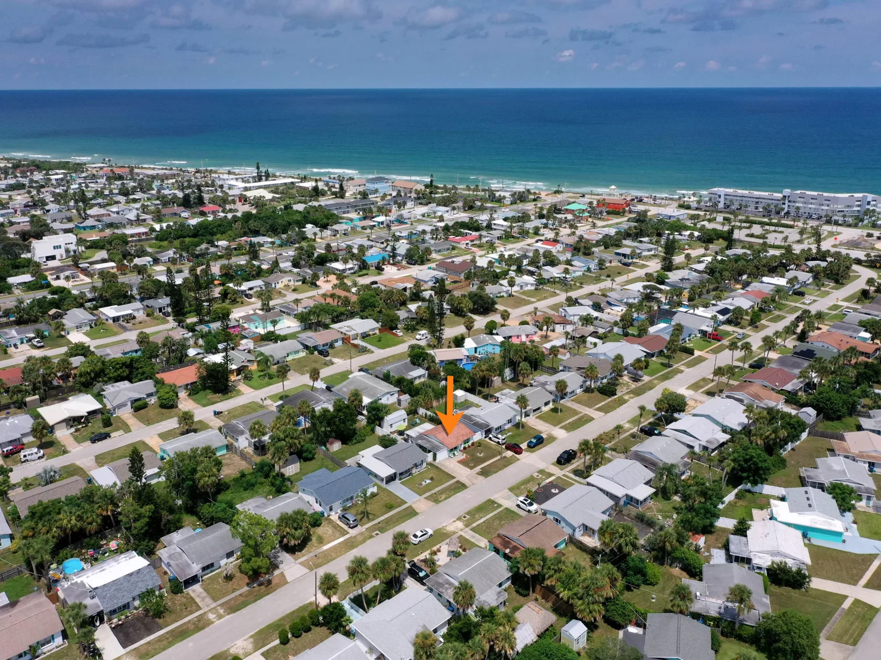 An aerial view of a coastal neighborhood beside the ocean.