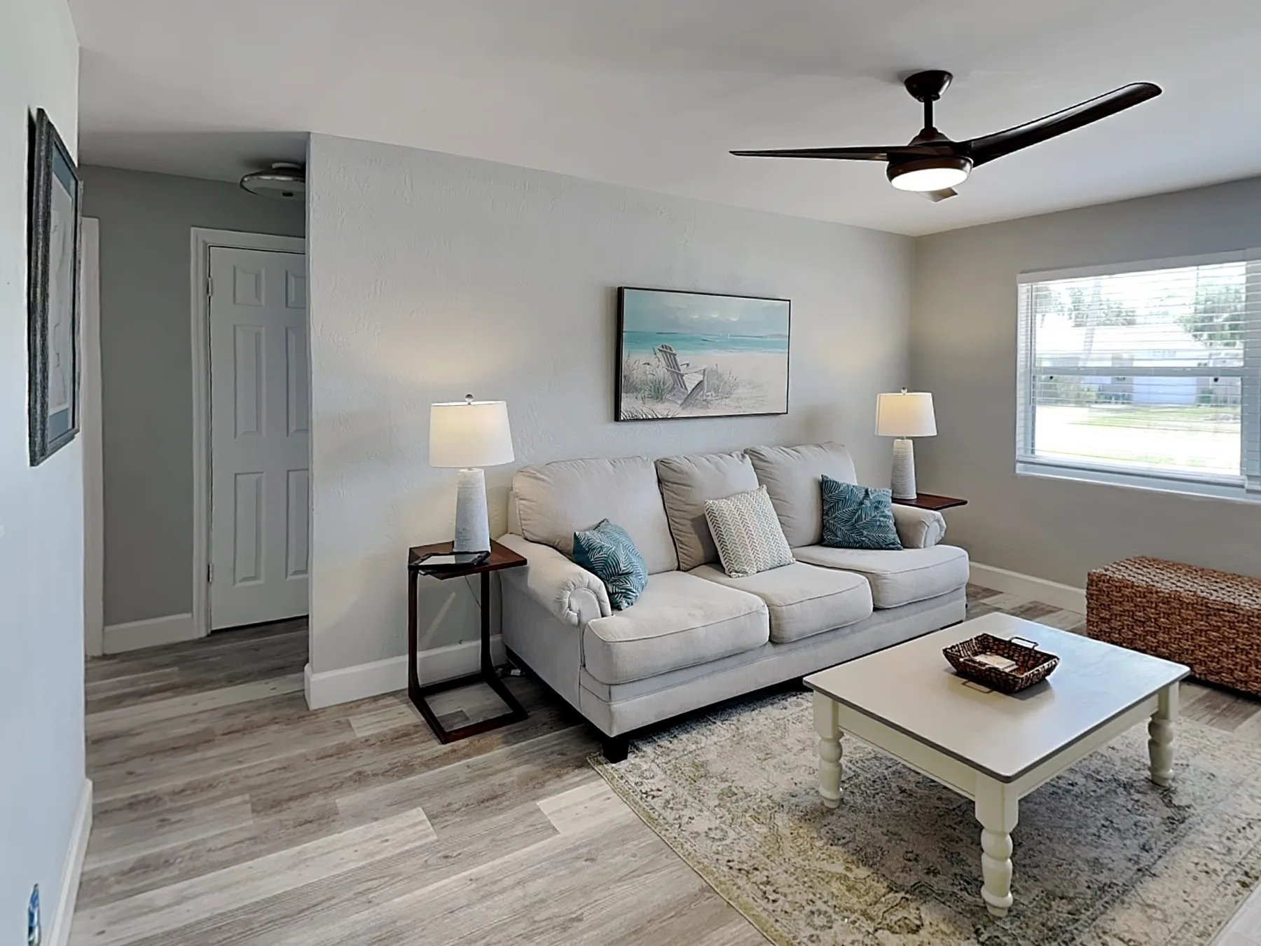 A bright living room with a light sofa and a coffee table.
