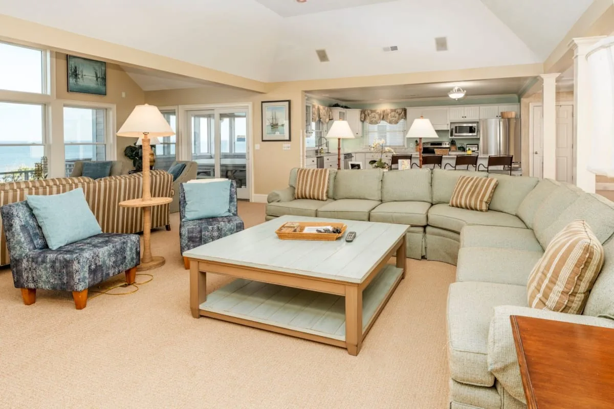 A living room with a sectional seating area and a coffee table.