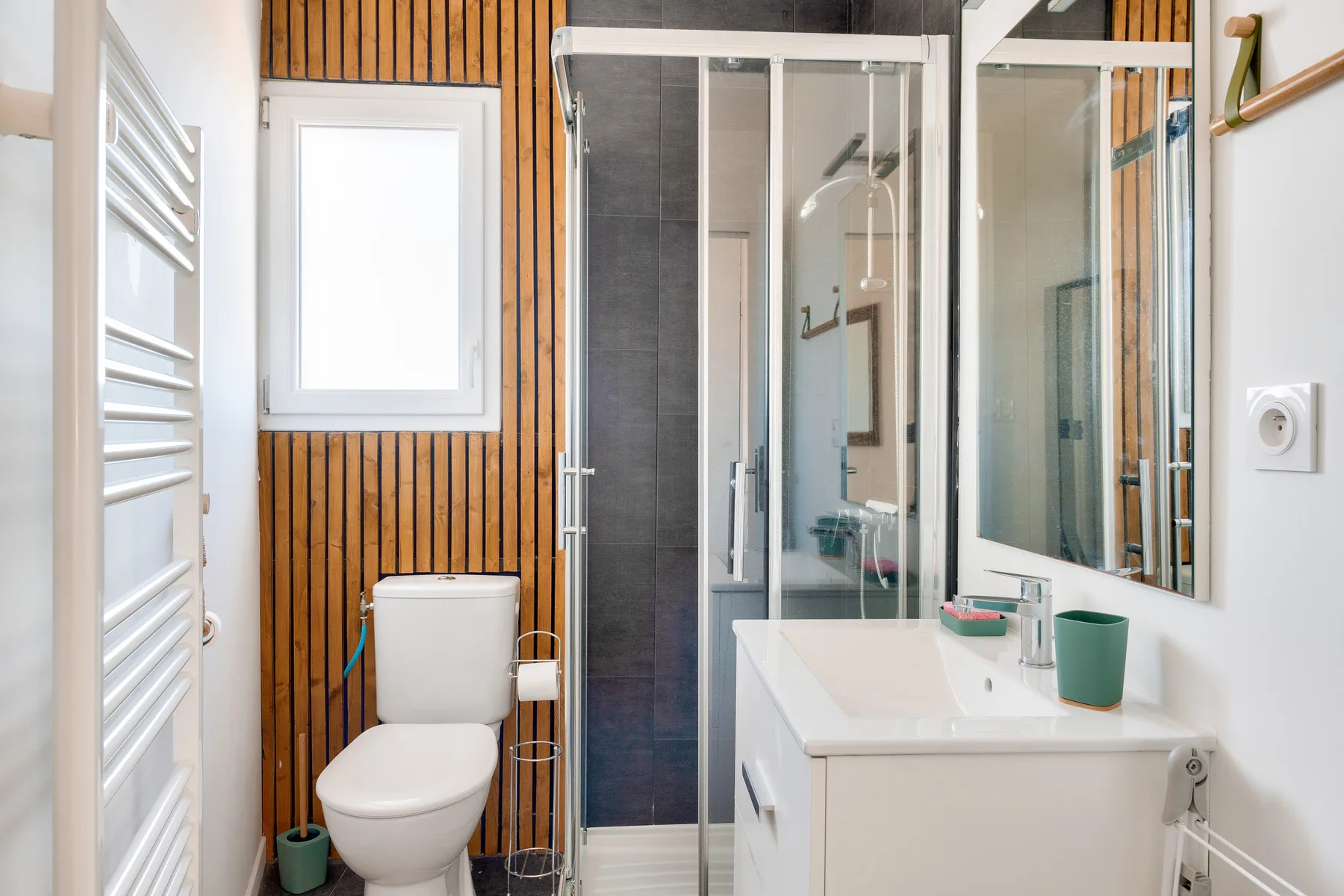 A bathroom with a shower, toilet, and sink.