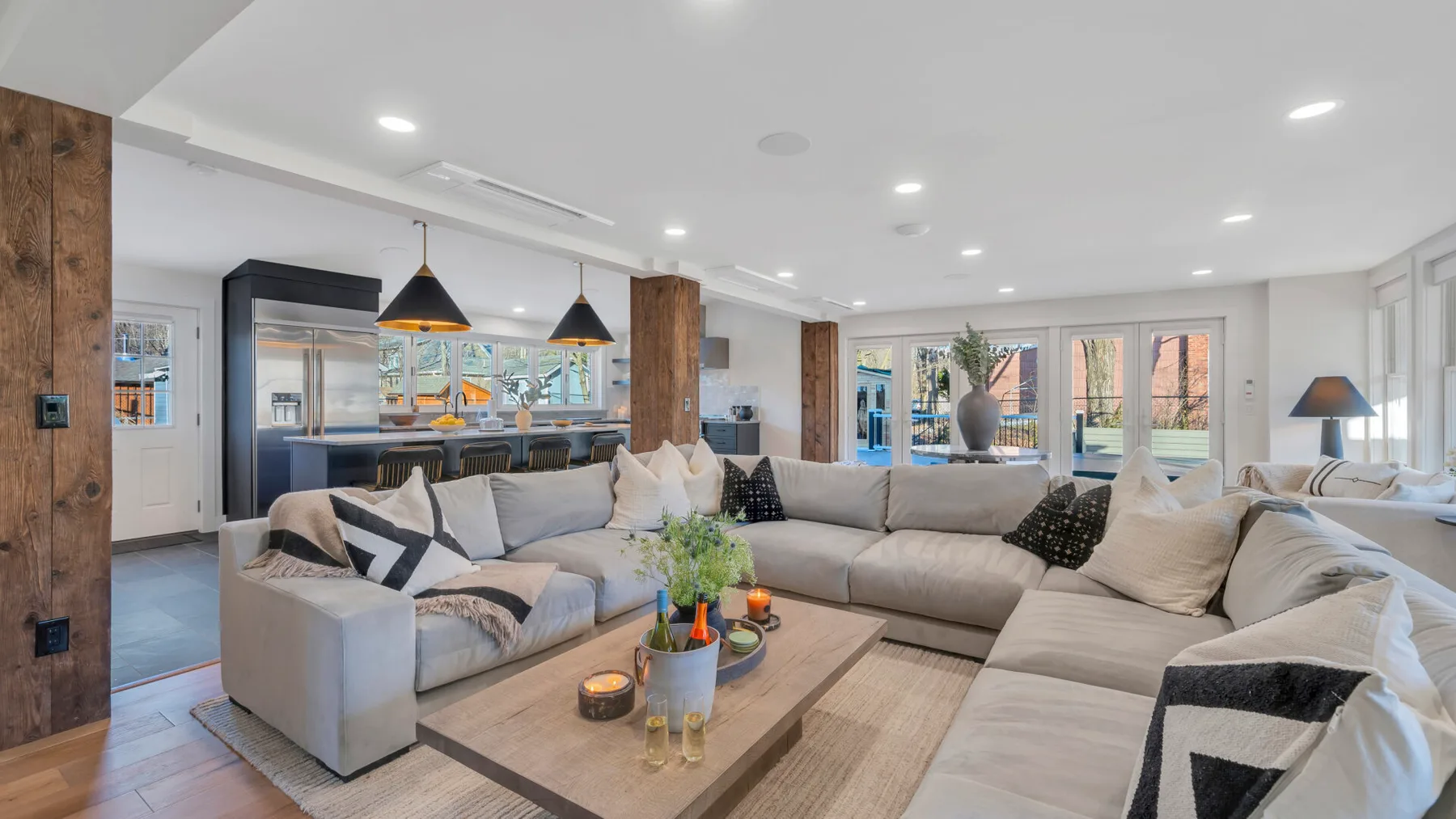 A bright living room with sectional seating around a low coffee table.