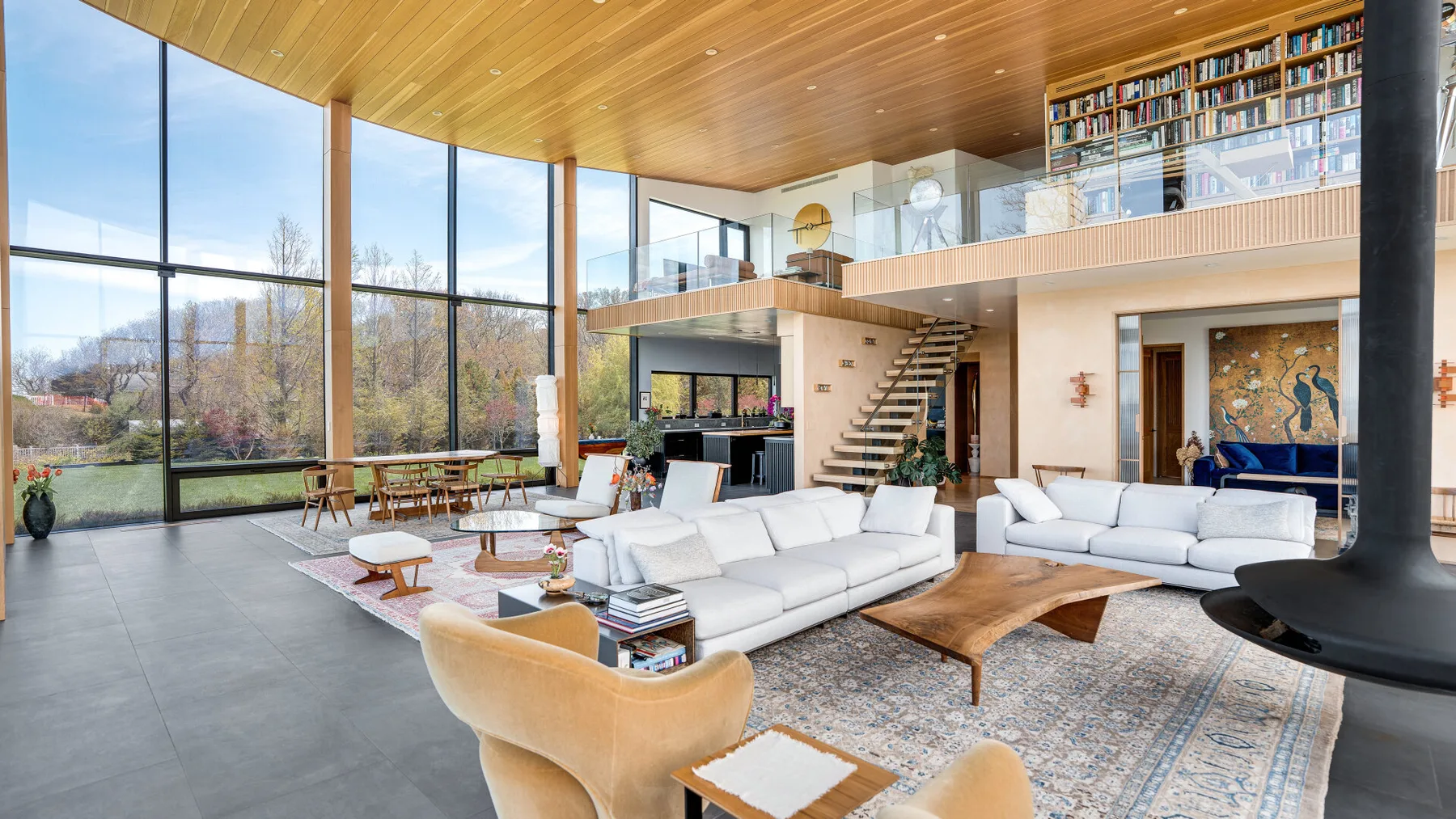 A bright living room with seating arranged around a low wooden coffee table.