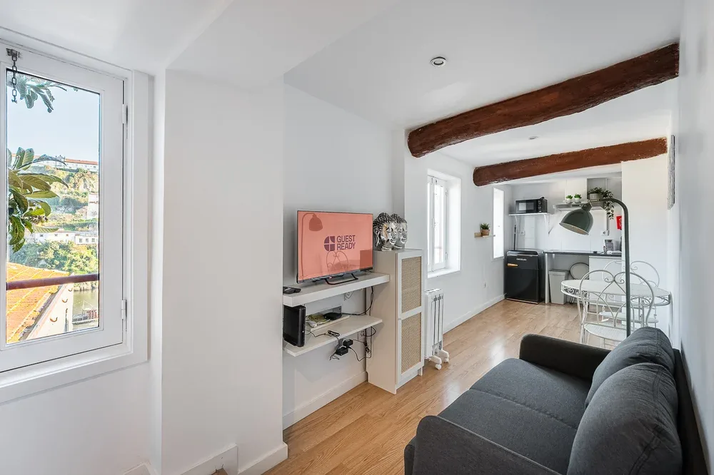 A bright living area opens into a compact kitchen and dining space.