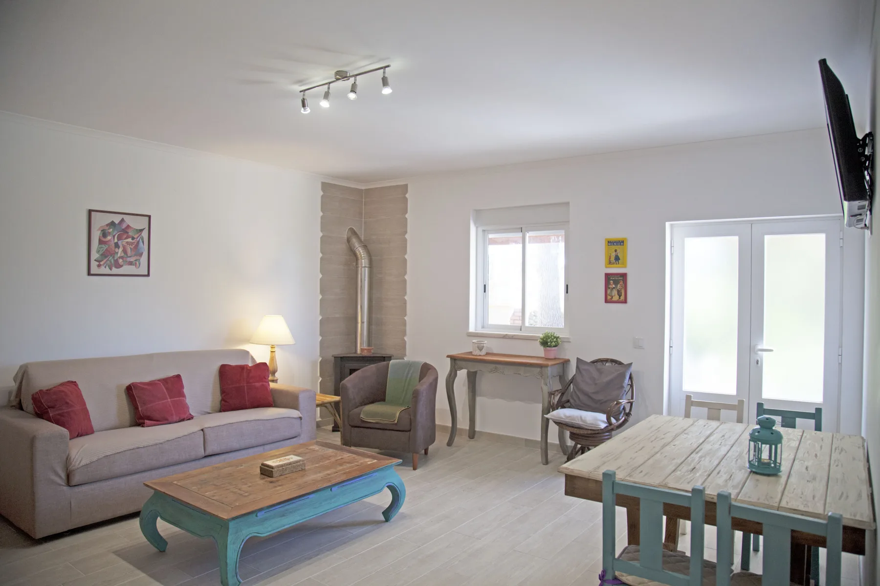 A living and dining area with seating, a coffee table, and a dining table.