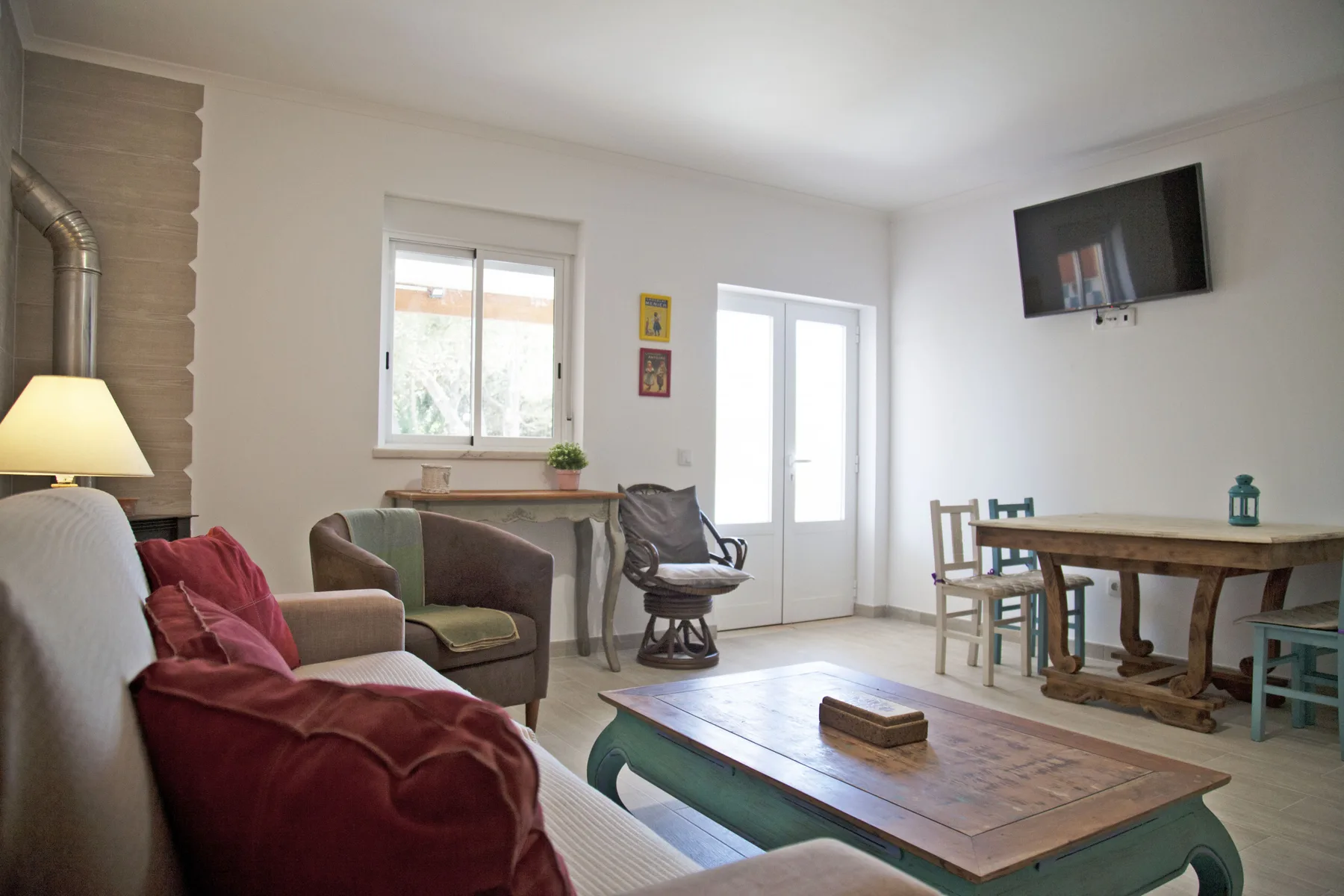 A living room with seating, a coffee table, and a dining table.