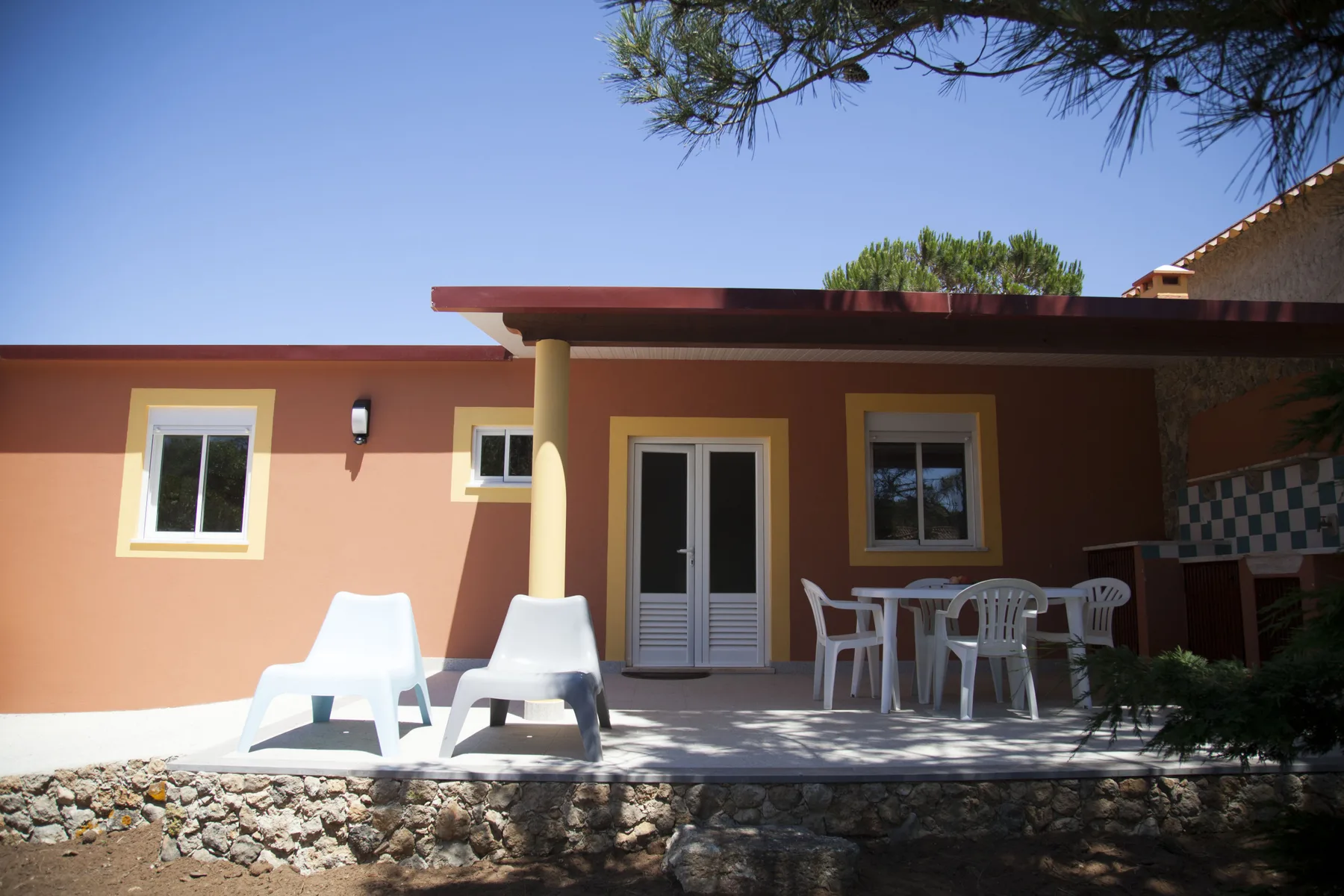 A house patio with outdoor seating and doors opening onto the terrace.