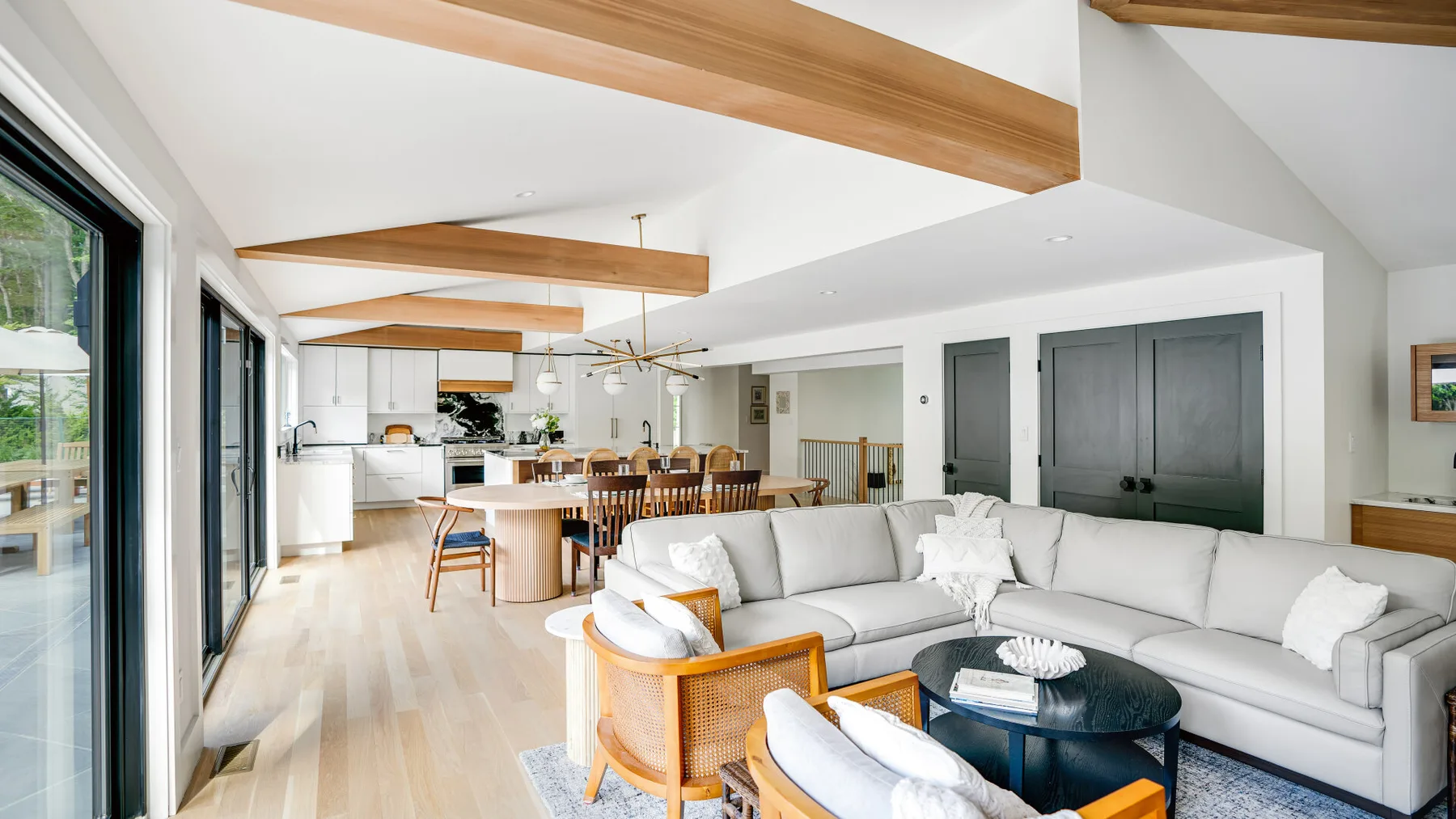 An open-plan living and dining area with a sectional seating area and dining table.