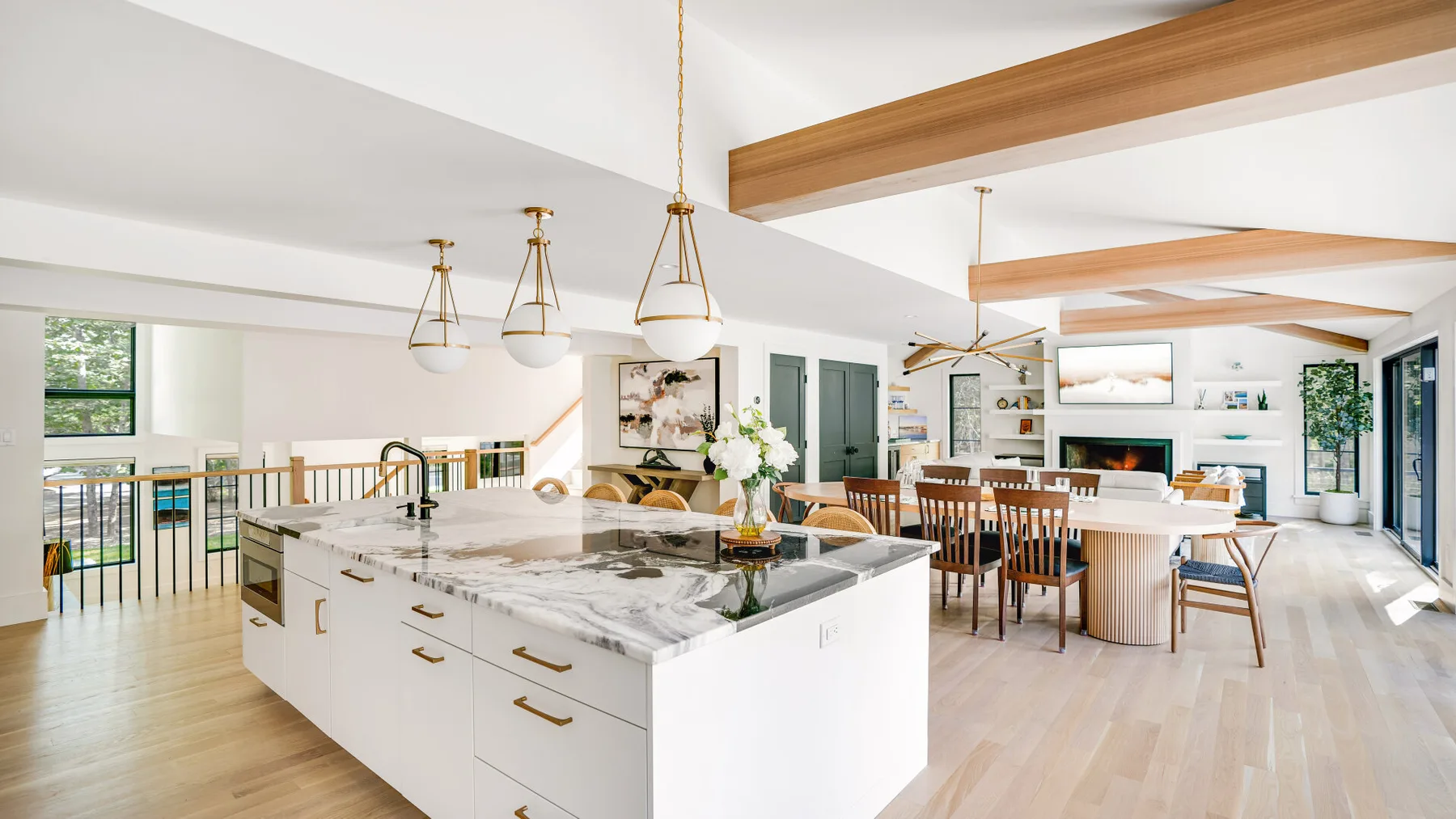 A bright open-plan kitchen and dining area with a large central island.