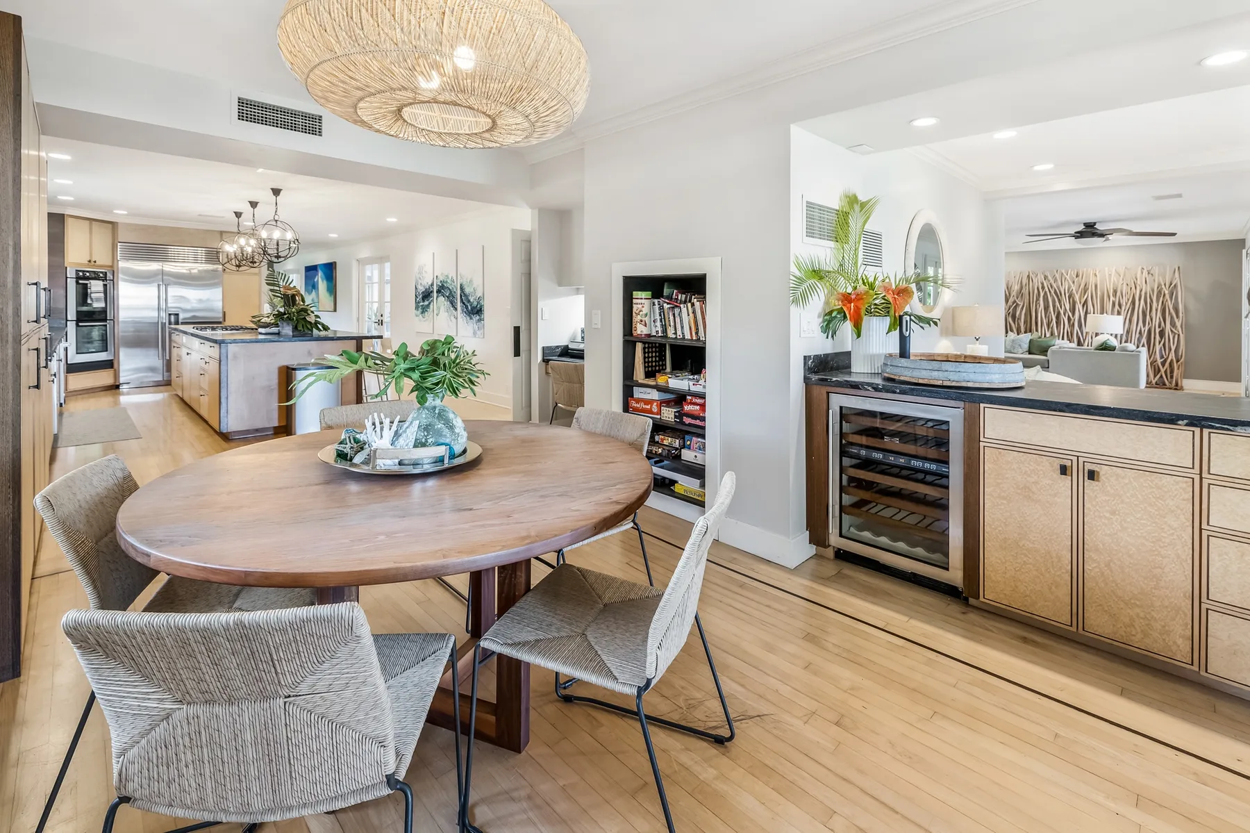 An open-plan dining and kitchen area with a round table and a kitchen island.