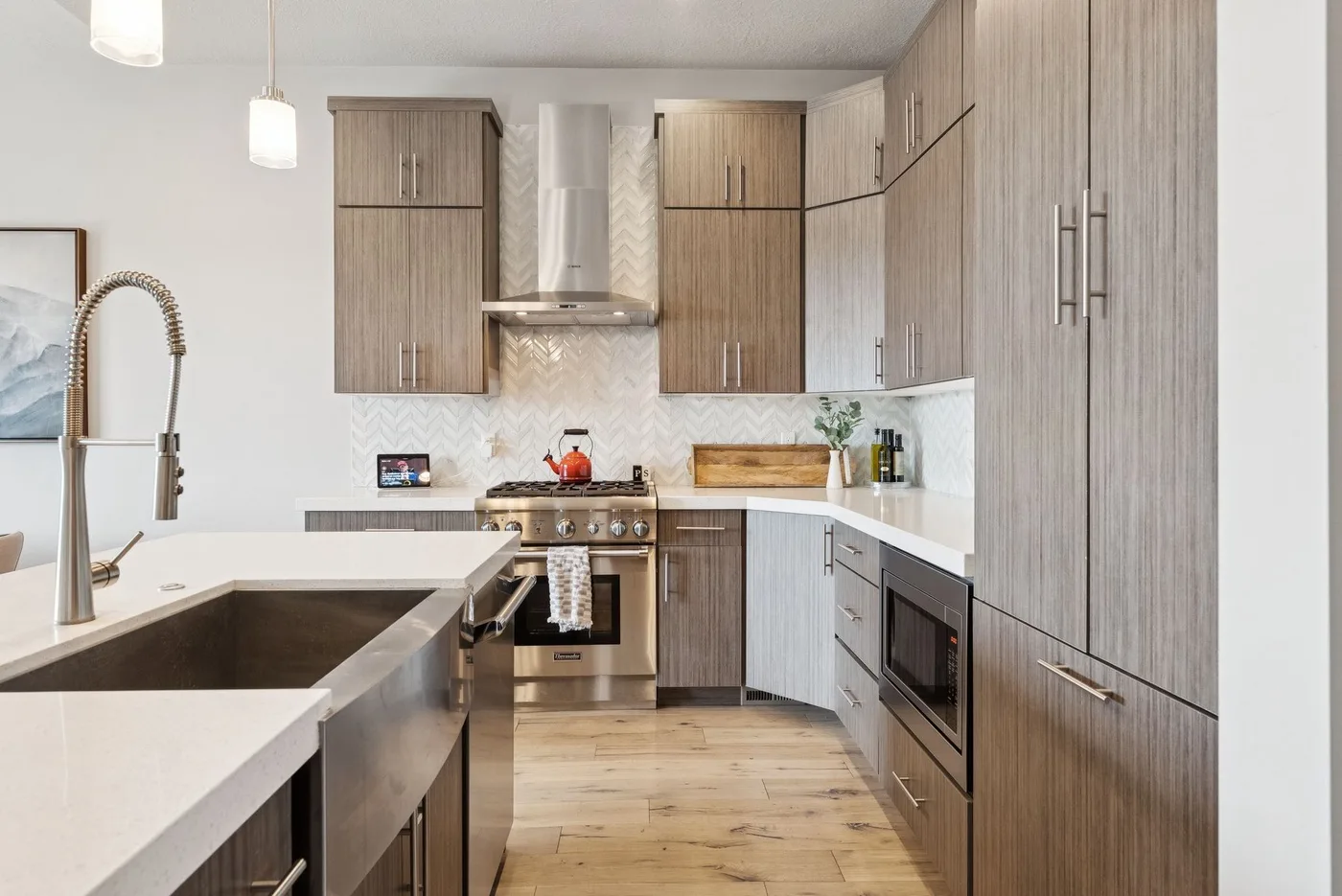 A modern kitchen with wood cabinetry, a stove, and a long counter.