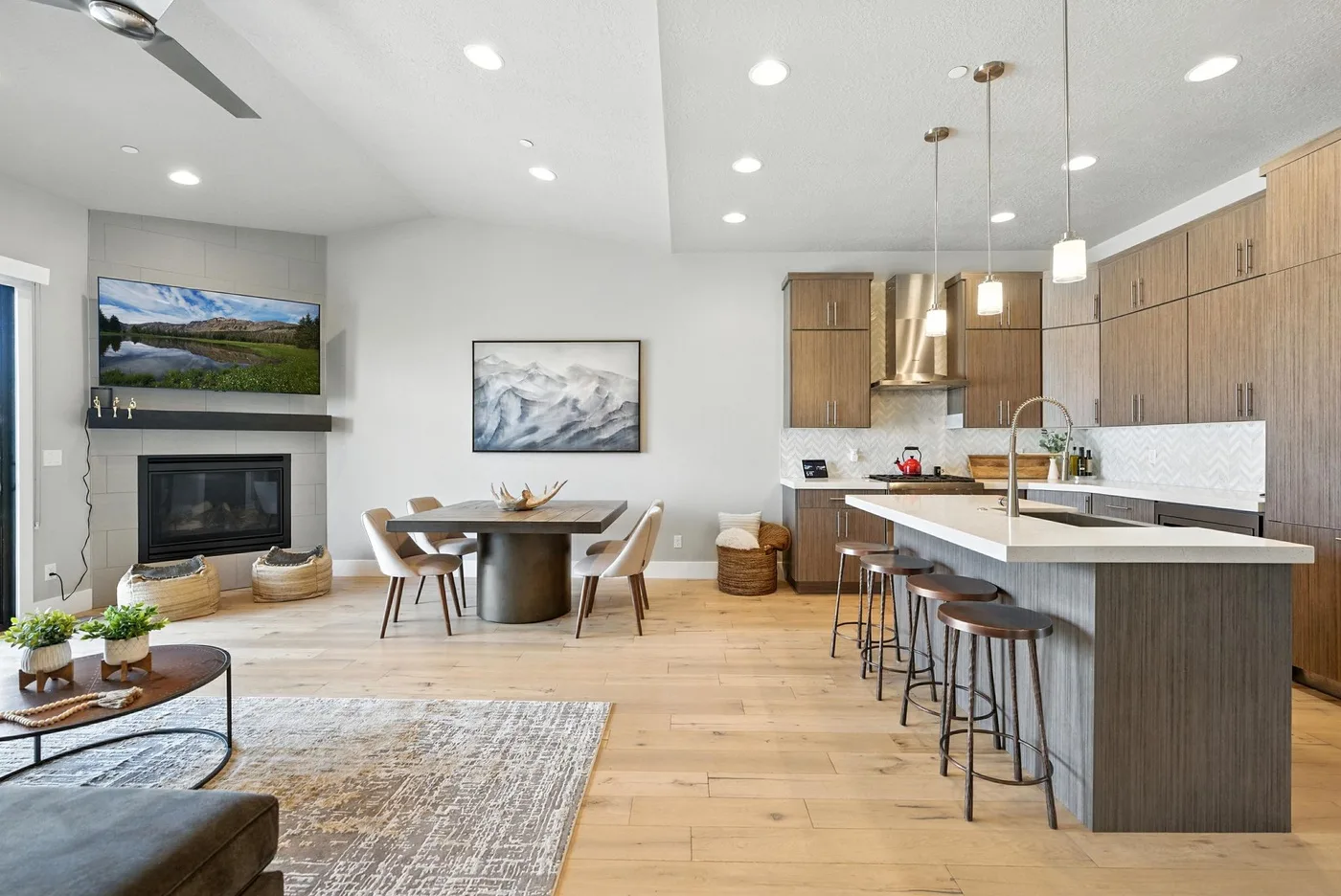 An open-plan living and dining area with a kitchen island and bar seating.