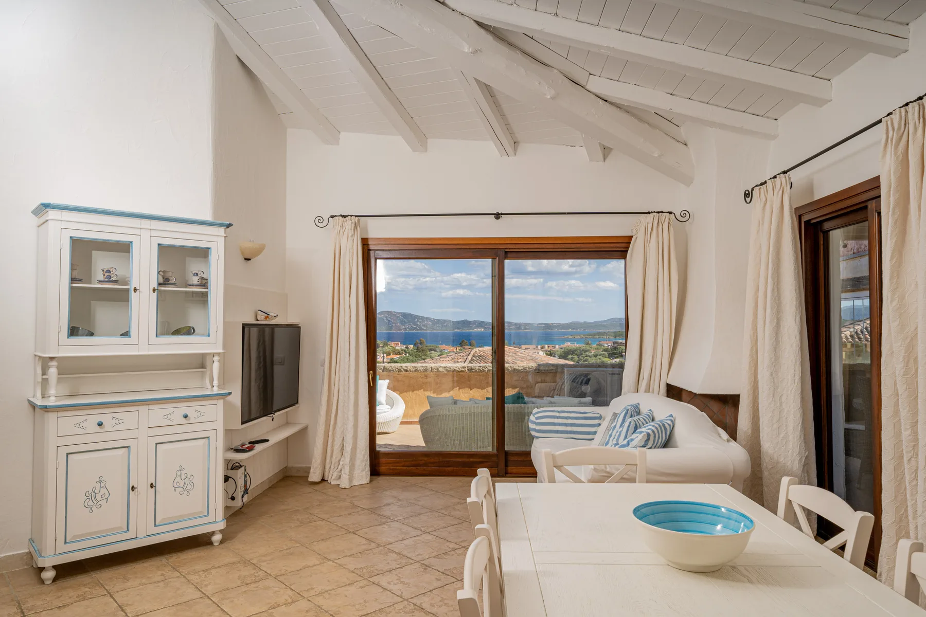 Una luminosa sala de estar y comedor da a una terraza con vistas al mar.