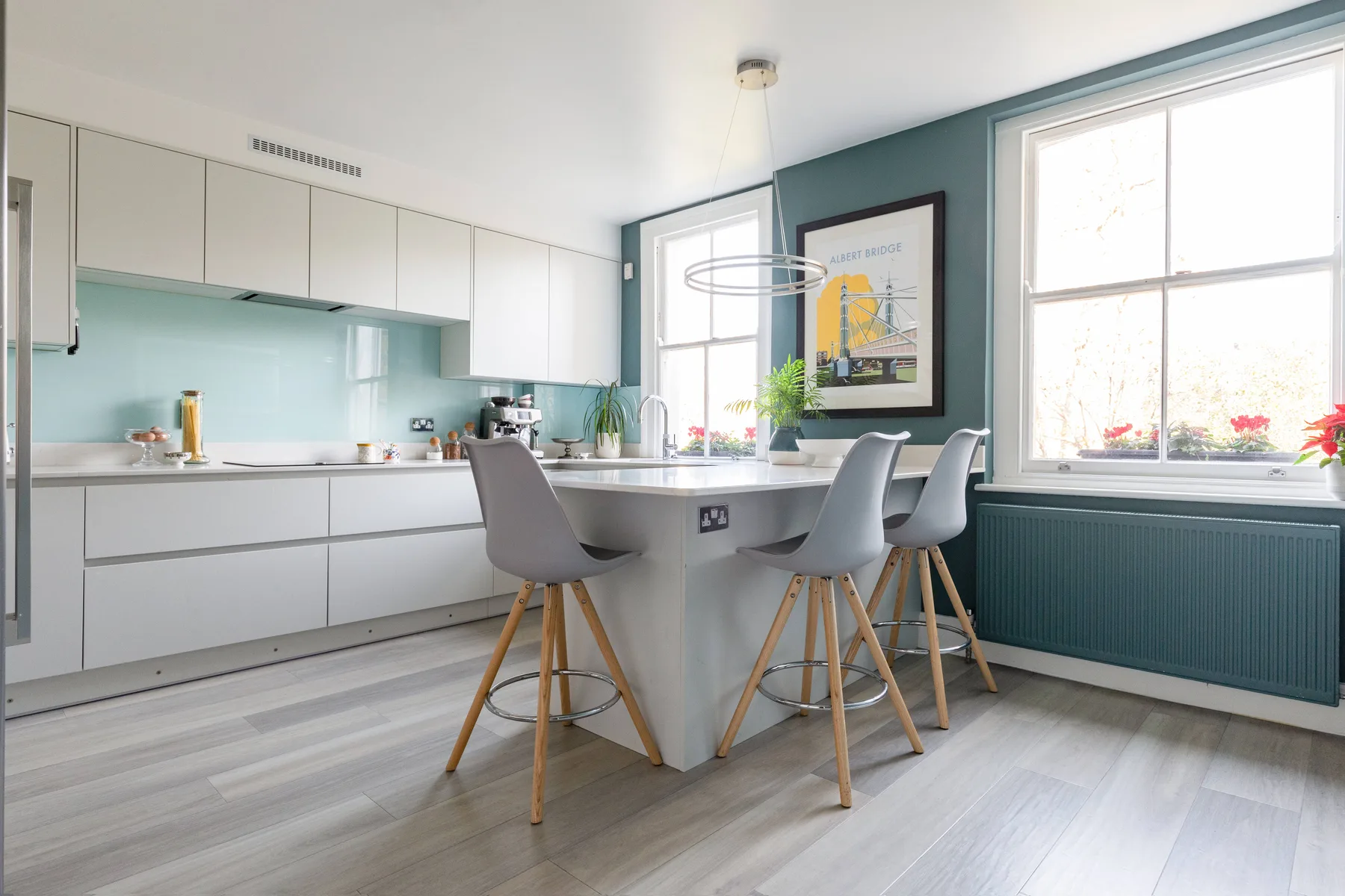 A bright kitchen and dining area with a central island and seating.