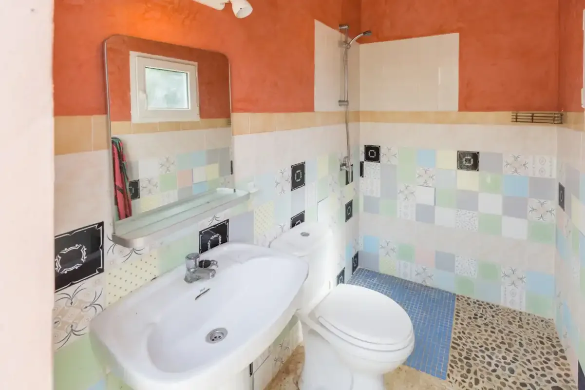 A bathroom with a sink, toilet, and shower.